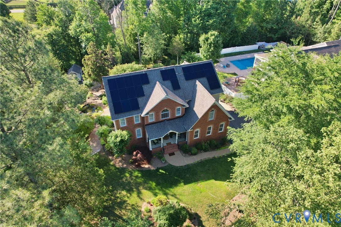 12669 Fawn Lane, Goochland, VA 23233 Brick exterior residence with solar panels, a gabled roof, covered porch, and an in-ground swimming pool