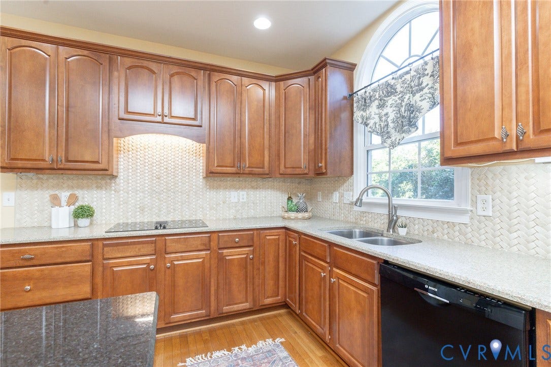 12669 Fawn Lane, Goochland, VA 23233 Recessed lighting illuminates a cooktop with a mosaic tile backsplash
