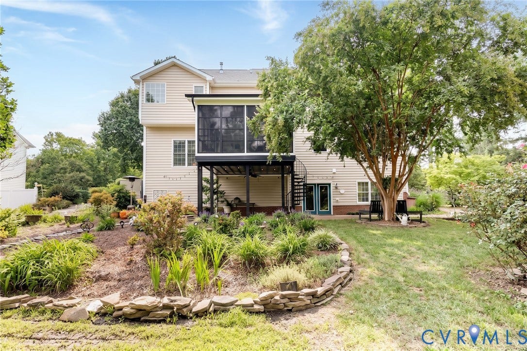 12669 Fawn Lane, Goochland, VA 23233 Exterior featuring a screened porch, open patio, spiral staircase, and established landscaping