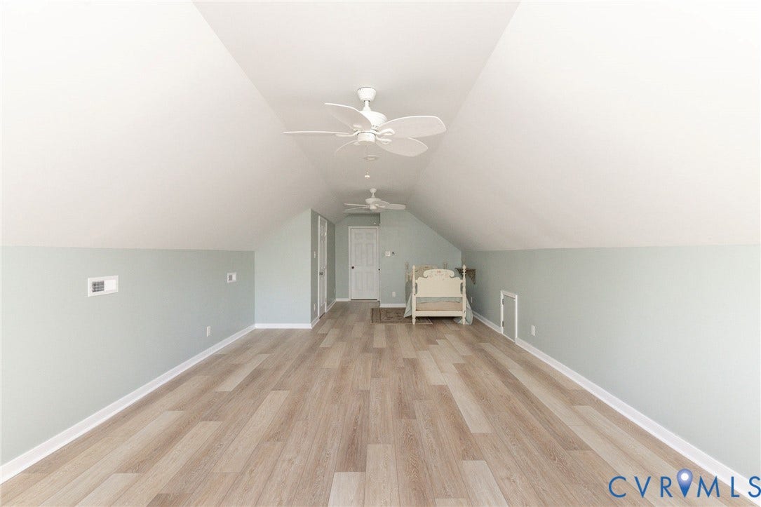 12669 Fawn Lane, Goochland, VA 23233 Vaulted ceilings with ceiling fans, wood-finish flooring, light-colored walls, and a white door with trim