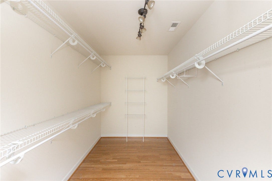 12669 Fawn Lane, Goochland, VA 23233 Wood-finish flooring with white wire shelving, track lighting, and a multi-tiered corner shelving unit