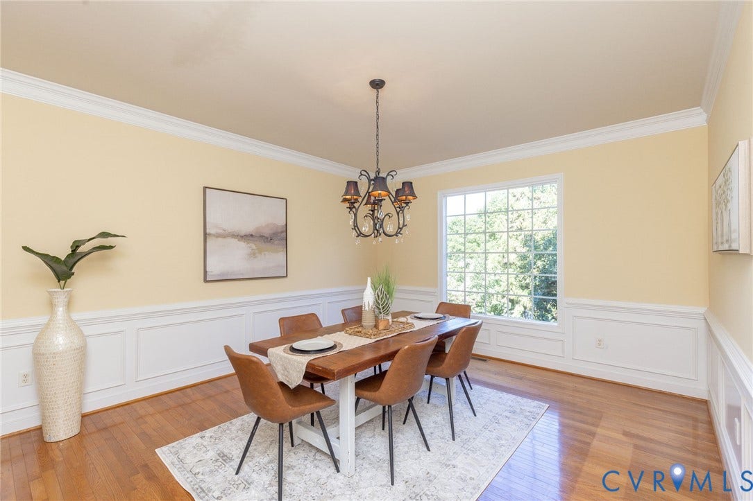 12669 Fawn Lane, Goochland, VA 23233 Hardwood flooring, decorative wall paneling, crown molding, a large multi-pane window, and an overhead chandelier