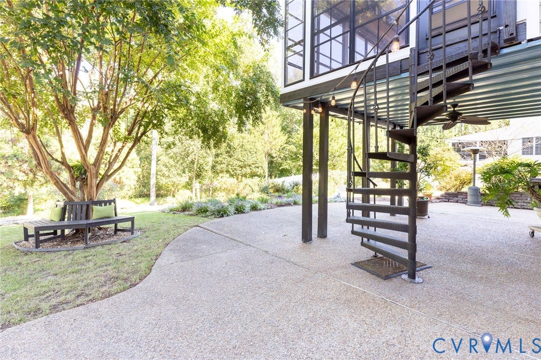 12669 Fawn Lane, Goochland, VA 23233 Exposed aggregate patio with a black spiral staircase, corrugated ceiling, and a ceiling fan