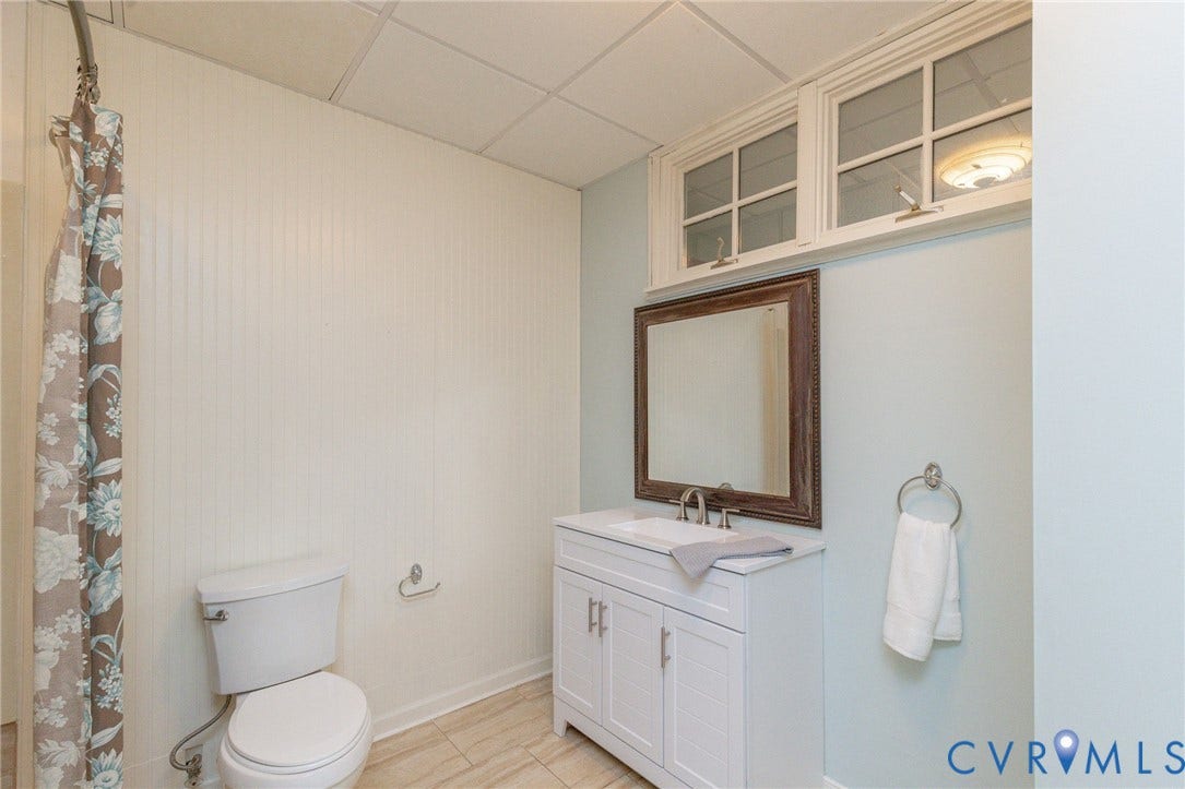 12669 Fawn Lane, Goochland, VA 23233 White shaker-style vanity with integrated sink, brushed nickel faucet, and wood-framed mirror