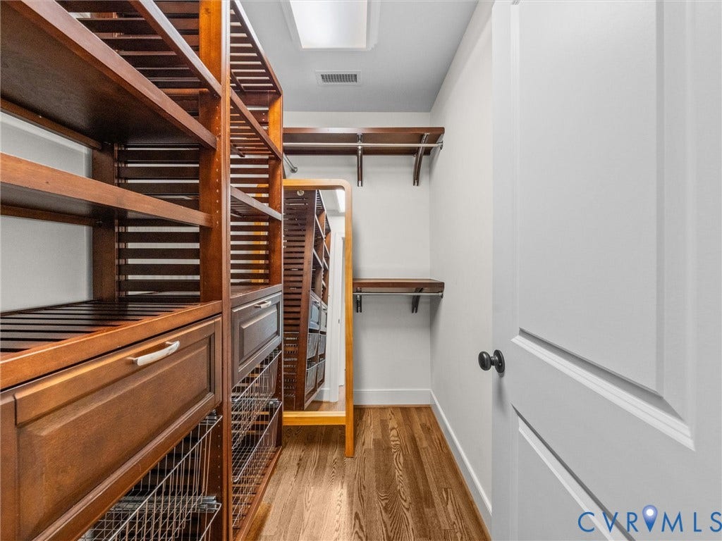 600 Baldwin Road, Henrico, VA 23229 Custom closet system featuring wood-finish shelving, integrated drawers, wire baskets, and hanging rods
