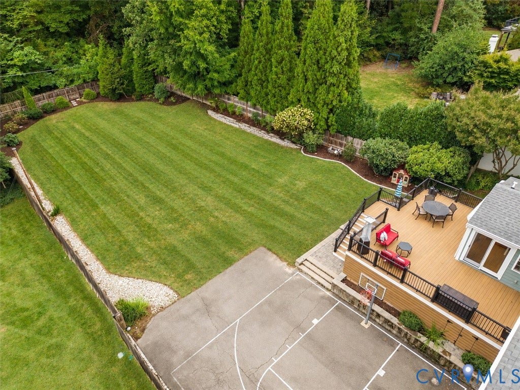 600 Baldwin Road, Henrico, VA 23229 Expansive green lawn framed by mature trees, multi-level composite deck, and paved court with basketball hoop