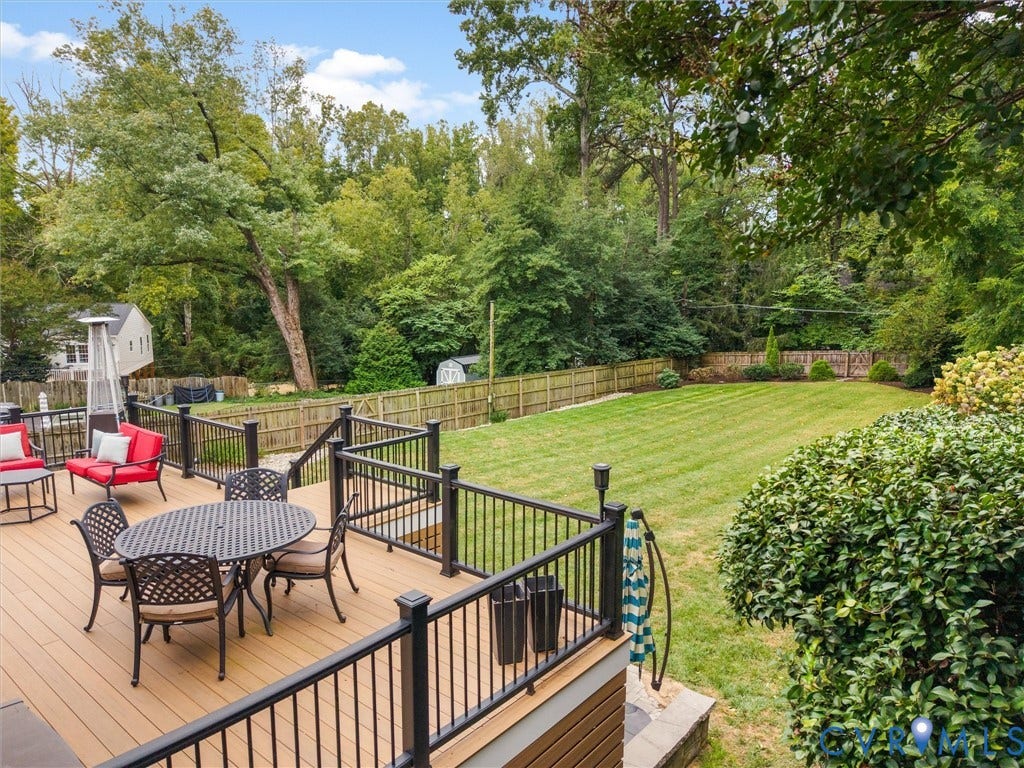 600 Baldwin Road, Henrico, VA 23229 Expansive backyard featuring a large green lawn, wood-toned decking, and black railings