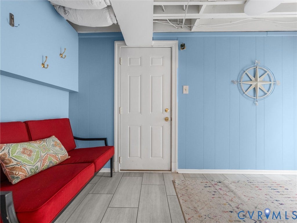 600 Baldwin Road, Henrico, VA 23229 Light blue paneling, wood-finish flooring, and a solid core door