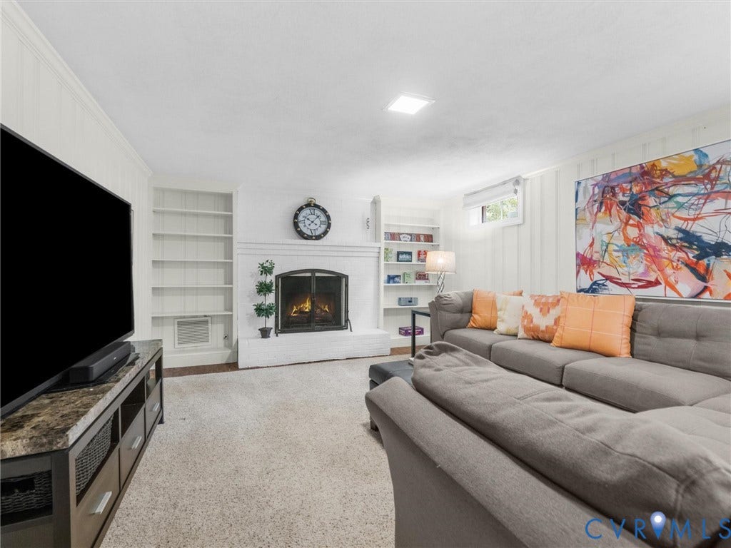 600 Baldwin Road, Henrico, VA 23229 Built-in shelving, fireplace, recessed lighting, and wall paneling