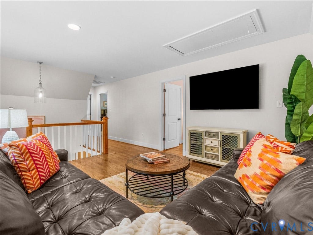 600 Baldwin Road, Henrico, VA 23229 Hardwood flooring, white painted railings, recessed lighting, and a contemporary pendant light fixture