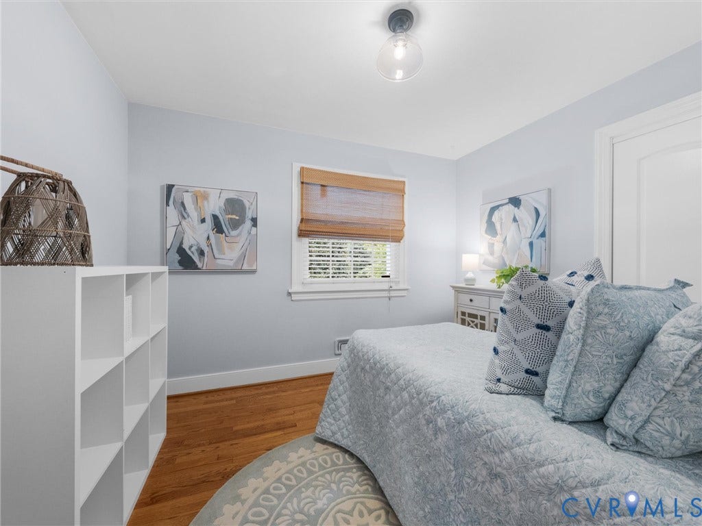 600 Baldwin Road, Henrico, VA 23229 Hardwood flooring, single window with blinds, surface-mount ceiling light fixture, white interior door, and built-in shelving unit