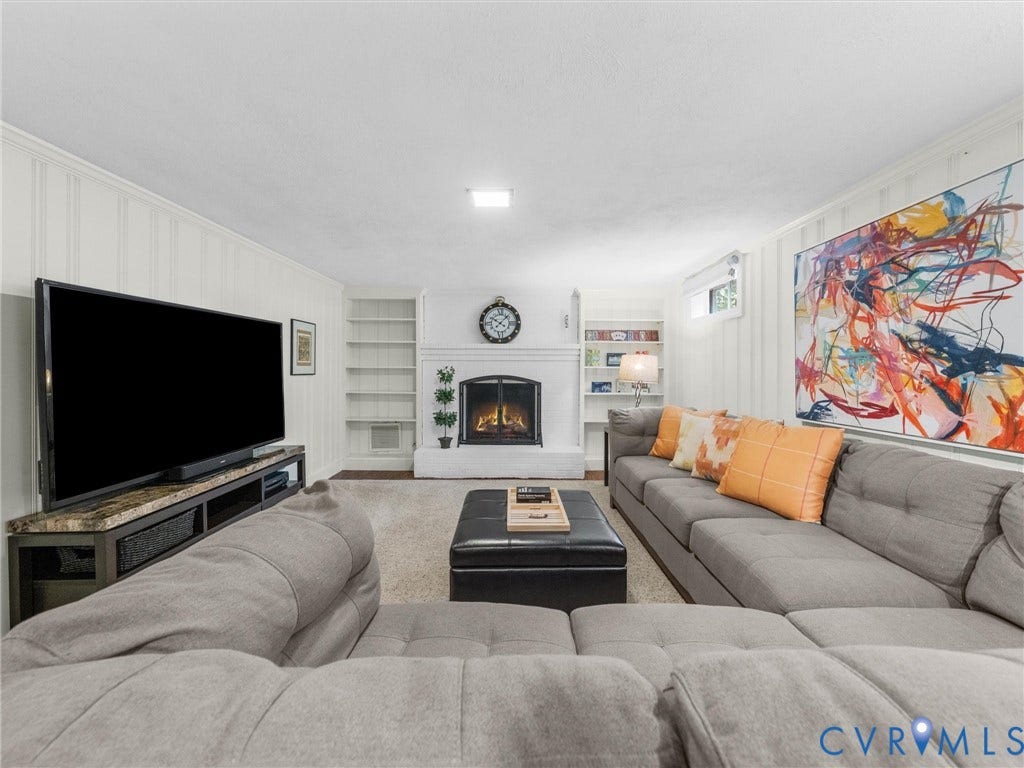 600 Baldwin Road, Henrico, VA 23229 Built-in fireplace with a white surround, integrated shelving, and wall paneling