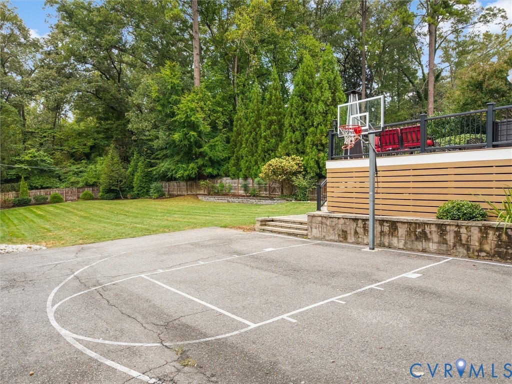 600 Baldwin Road, Henrico, VA 23229 Paved sport court with basketball hoop, adjacent to a flat, manicured lawn