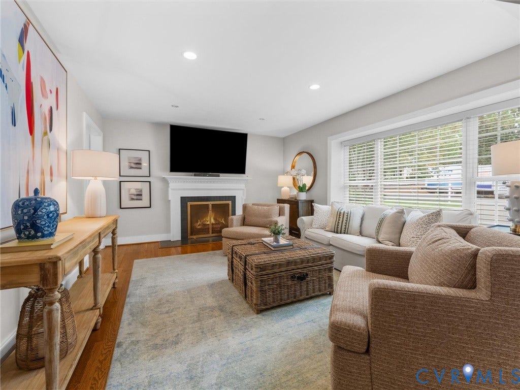600 Baldwin Road, Henrico, VA 23229 Hardwood flooring, fireplace with a classic white mantel, large windows with blinds, and recessed lighting