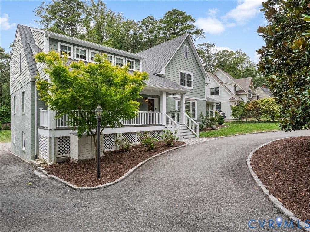600 Baldwin Road, Henrico, VA 23229 Light green siding exterior with a pitched roof, front porch with white railings, and a paved driveway