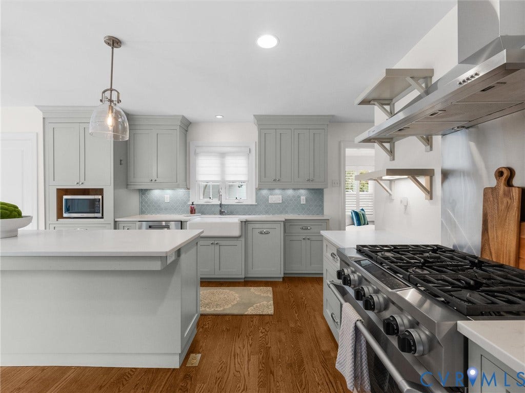 600 Baldwin Road, Henrico, VA 23229 Gourmet kitchen with wood-finish flooring, light gray cabinetry, stainless steel appliances, and white countertops
