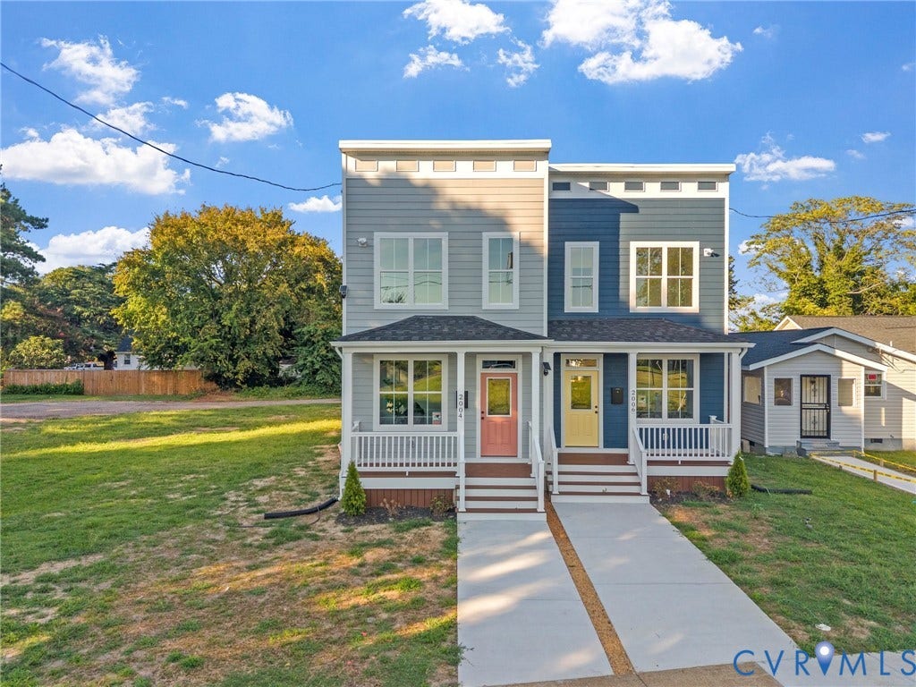 2000 Newbourne Street, Richmond, VA 23223 Two-story duplex featuring distinct colorful entry doors, individual covered front porches with white railings, and separate concrete walkways