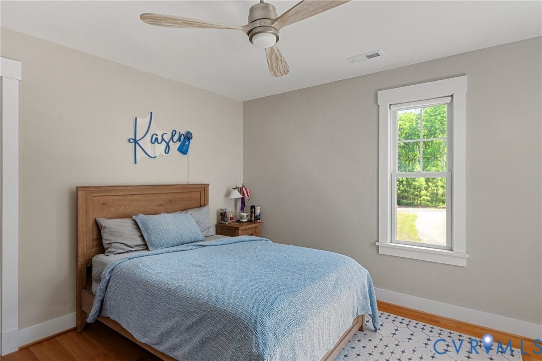 13003 Farrington Place Lane, Farrington Place, Hanover, VA 23059 Neutral wall color, wood-finish flooring, white trim detailing, ceiling fan, and a double-hung window