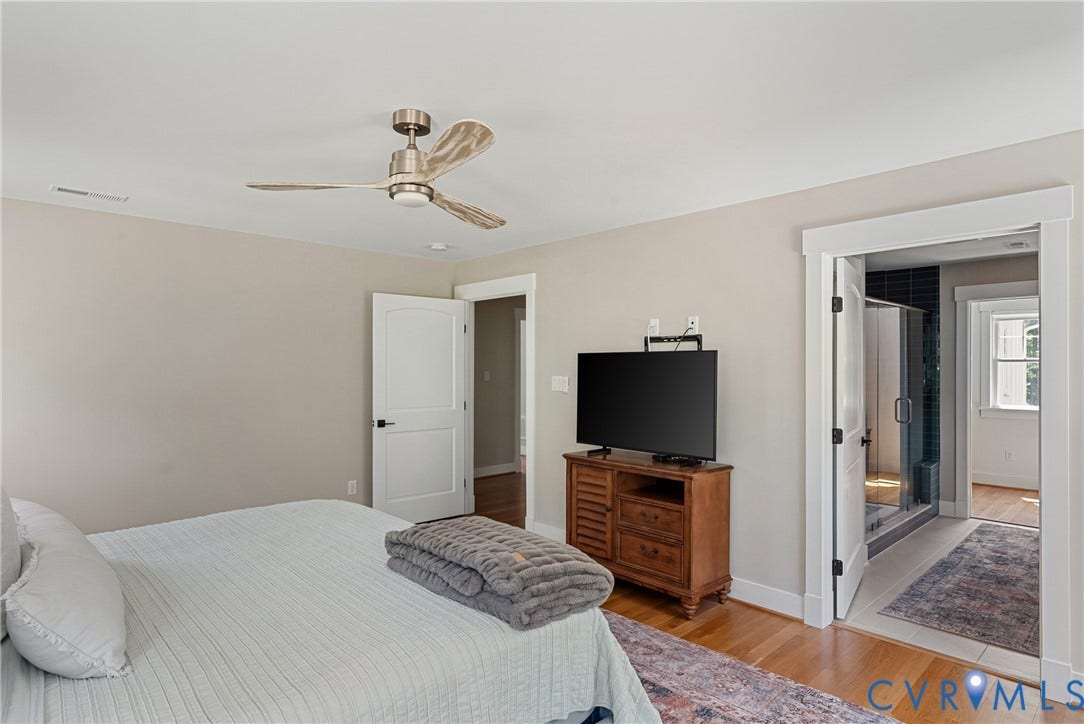 13003 Farrington Place Lane, Farrington Place, Hanover, VA 23059 Wood-finish flooring, ceiling fan with brushed nickel accents, and a wide cased opening
