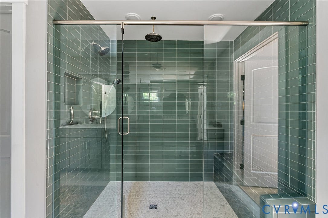 13003 Farrington Place Lane, Farrington Place, Hanover, VA 23059 Glass-enclosed shower featuring a rain showerhead, a wall-mounted showerhead, and subway tile walls