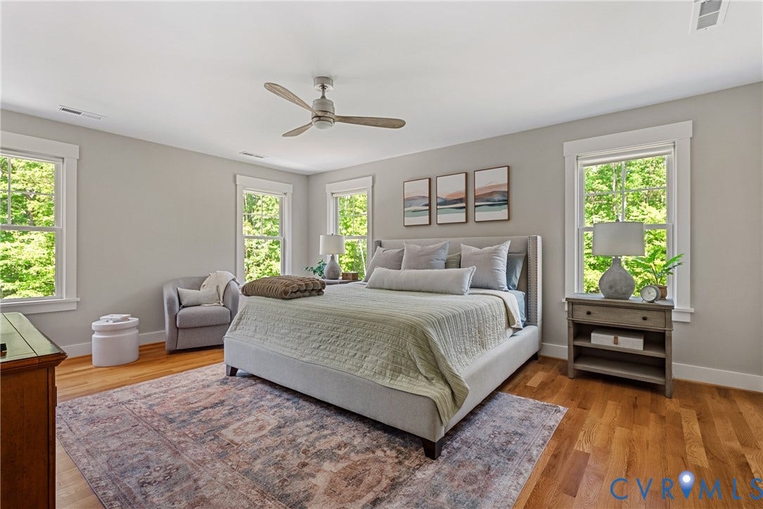 13003 Farrington Place Lane, Farrington Place, Hanover, VA 23059 Hardwood flooring, multiple windows with white trim, a ceiling fan, and light gray wall paint