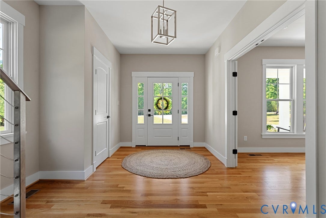 13003 Farrington Place Lane, Farrington Place, Hanover, VA 23059 Entryway featuring wood flooring, a transom window over the main door, and a modern geometric pendant light fixture