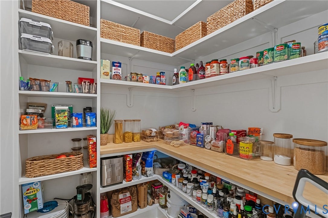 13003 Farrington Place Lane, Farrington Place, Hanover, VA 23059 Custom storage pantry featuring white shelving, a wood-finish countertop, and built-in vertical storage