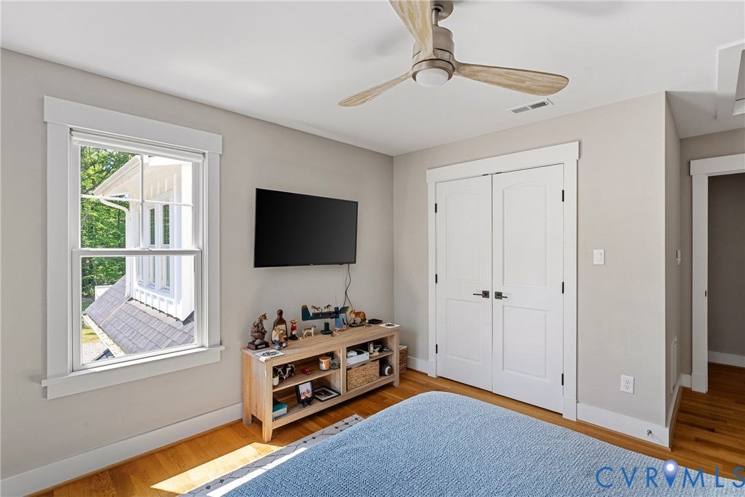 13003 Farrington Place Lane, Farrington Place, Hanover, VA 23059 Hardwood flooring, bright window with white trim, built-in double-door closet, and a ceiling fan with light fixture
