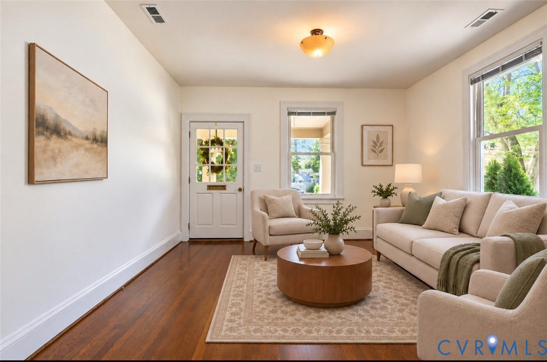 Hardwood flooring, freshly painted walls, cased openings, and ceiling light fixture