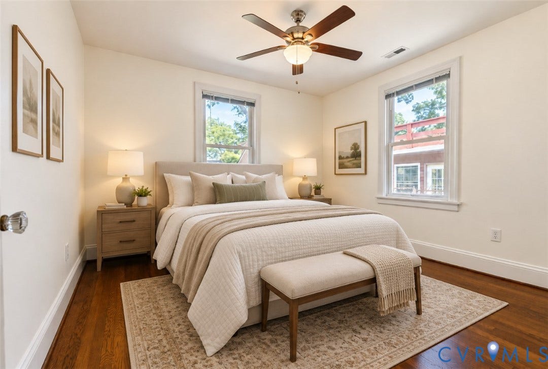 Hardwood flooring, freshly painted walls, ceiling fan with integrated lighting, two windows, and white trim