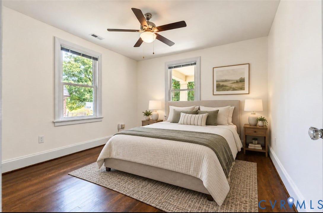 Hardwood flooring, two windows with white trim, ceiling fan with integrated lighting, and neutral wall tones