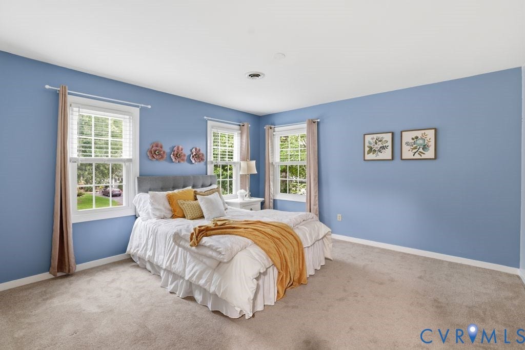 9612 Kingscroft Drive, Glen Allen, VA 23060 Bedroom featuring two windows with white blinds, light blue walls, and neutral carpet flooring