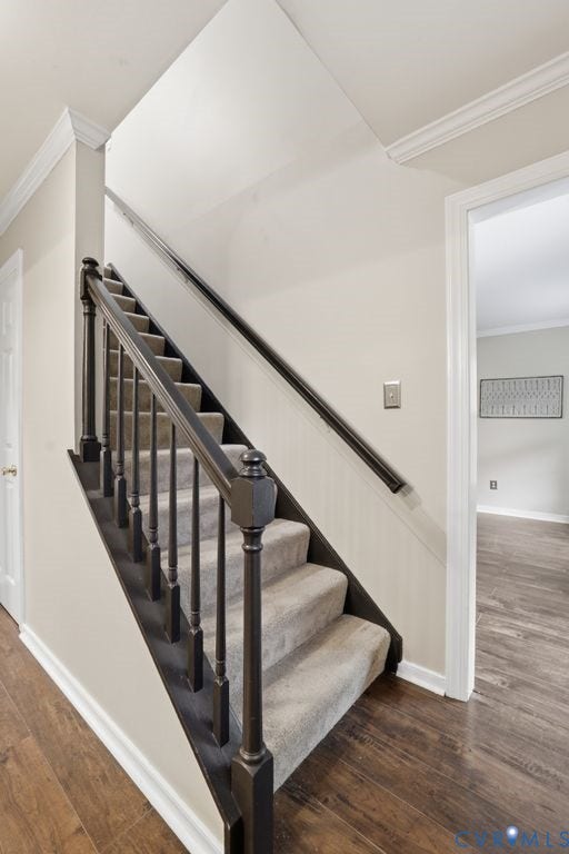 9612 Kingscroft Drive, Glen Allen, VA 23060 Staircase featuring dark wood newel posts, balusters, and handrails