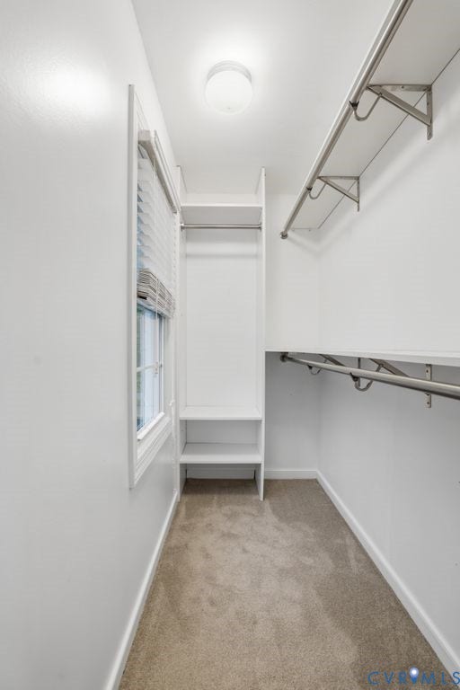 9612 Kingscroft Drive, Glen Allen, VA 23060 Walk-in closet featuring built-in shelving, chrome hanging rods, a window with blinds, overhead lighting, and carpet flooring
