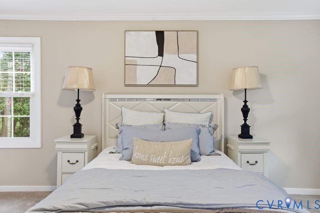 9612 Kingscroft Drive, Glen Allen, VA 23060 Bedroom featuring a white paneled headboard, matching white nightstands with drawer storage, and a double-hung window
