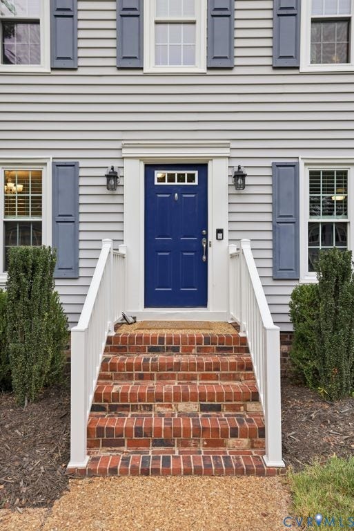 9612 Kingscroft Drive, Glen Allen, VA 23060 Classic Colonial entrance featuring a navy blue six-panel front door with brass hardware, flanked by symmetrical blue shutters and white trim