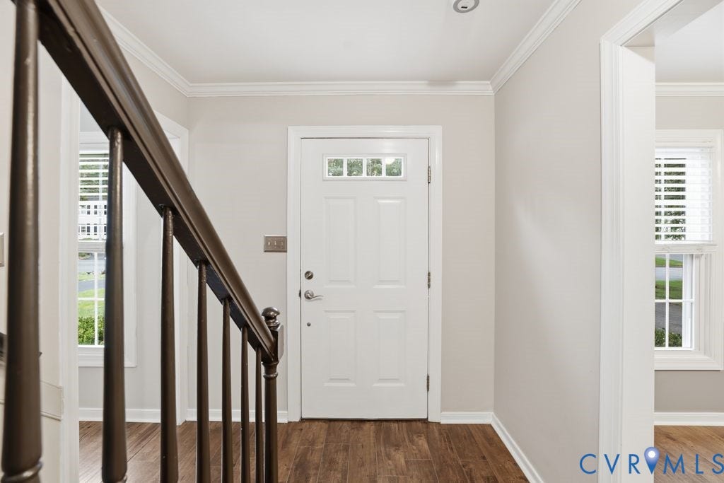 9612 Kingscroft Drive, Glen Allen, VA 23060 Entryway featuring a white paneled door with transom windows, wood-finish flooring, and crown molding