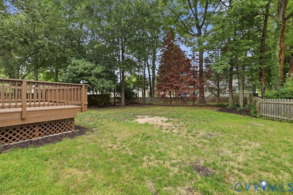 9612 Kingscroft Drive, Glen Allen, VA 23060 Expansive outdoor deck with lattice skirting, surrounded by mature trees