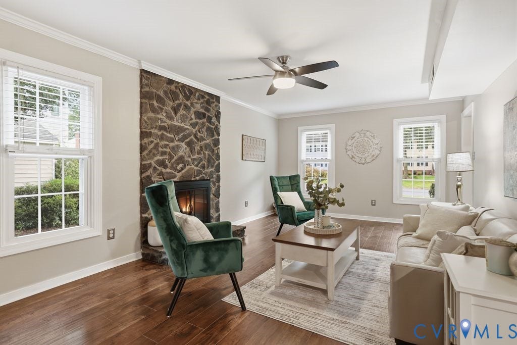 9612 Kingscroft Drive, Glen Allen, VA 23060 Stone-clad fireplace with a dark metal firebox, set against warm gray walls