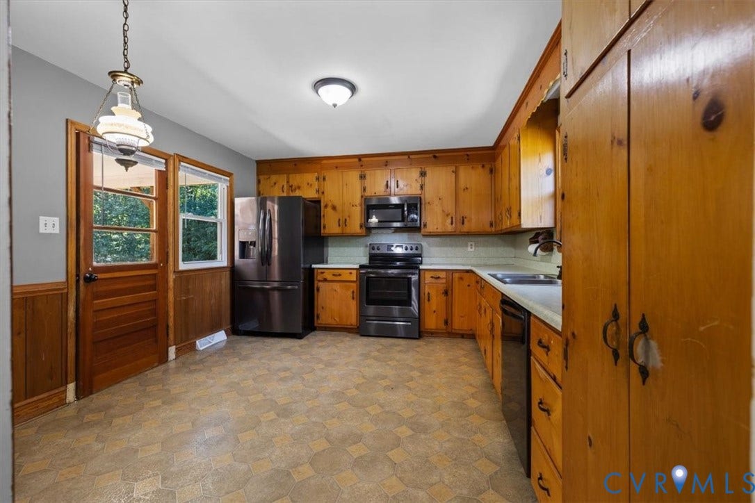 3577 Old Buckingham Road, Powhatan, VA 23139 Kitchen featuring wood cabinetry, stainless steel appliances, a ceiling-mounted light fixture, and a patterned floor