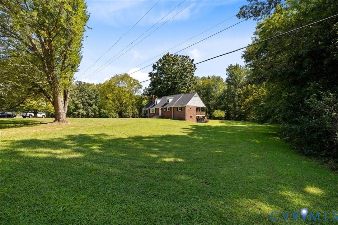 3577 Old Buckingham Road, Powhatan, VA 23139 Expansive grassy area with mature trees and a brick-clad residence
