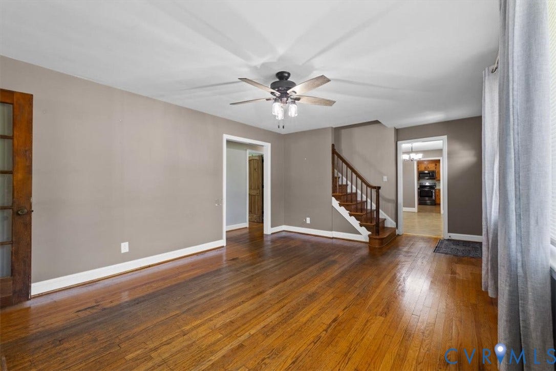 3577 Old Buckingham Road, Powhatan, VA 23139 Hardwood flooring, neutral wall tones, interior staircase with wood railing, ceiling fan with light fixture, and French pane door