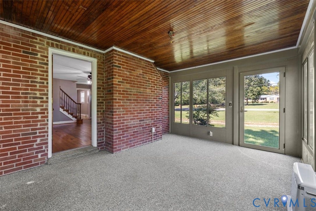 3577 Old Buckingham Road, Powhatan, VA 23139 Enclosed sunroom with wood-finish ceiling, brick wall, light-colored carpeting, and multiple windows