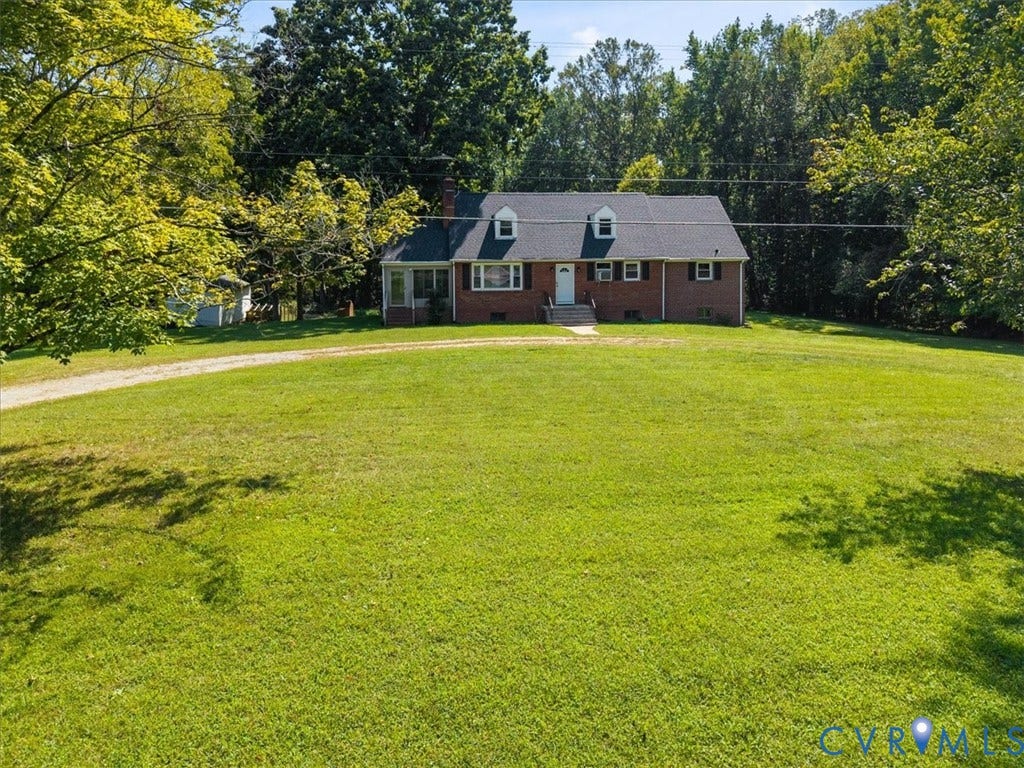 3577 Old Buckingham Road, Powhatan, VA 23139 Brick exterior residence featuring a gabled roof, white dormer windows, and a screened-in porch