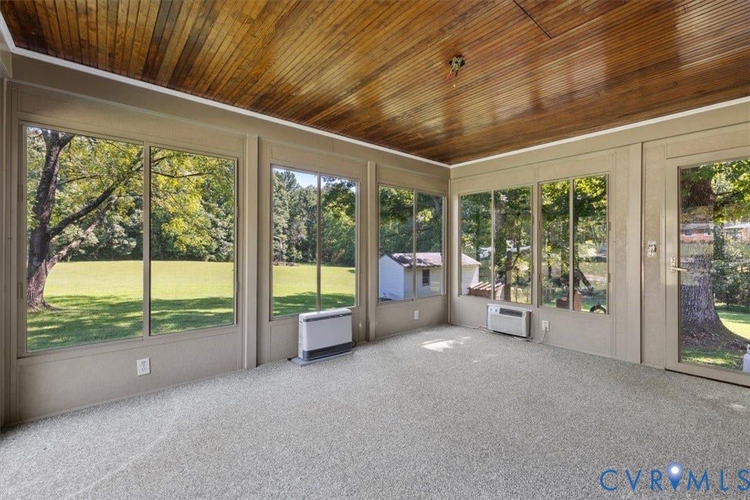 3577 Old Buckingham Road, Powhatan, VA 23139 Enclosed porch featuring a wood-paneled ceiling, wall-to-wall carpeting, multiple windows, and a glass-paneled door