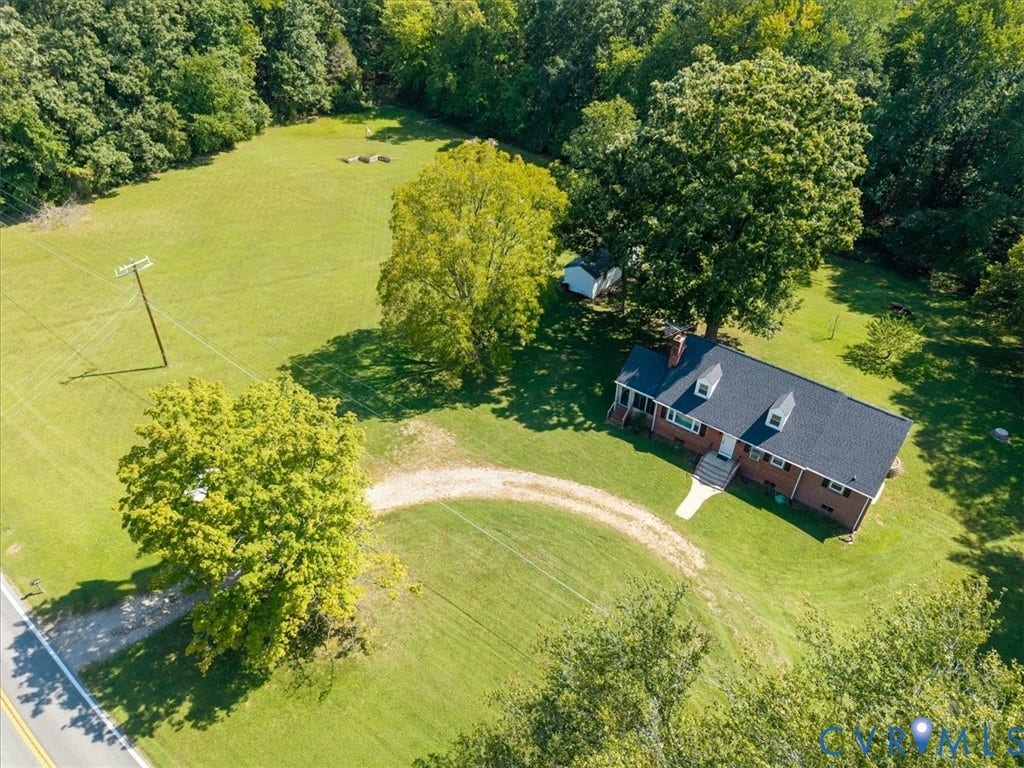 3577 Old Buckingham Road, Powhatan, VA 23139 Single-story brick residence with a dark shingle roof and dormer windows, set on a expansive grass lot with mature trees