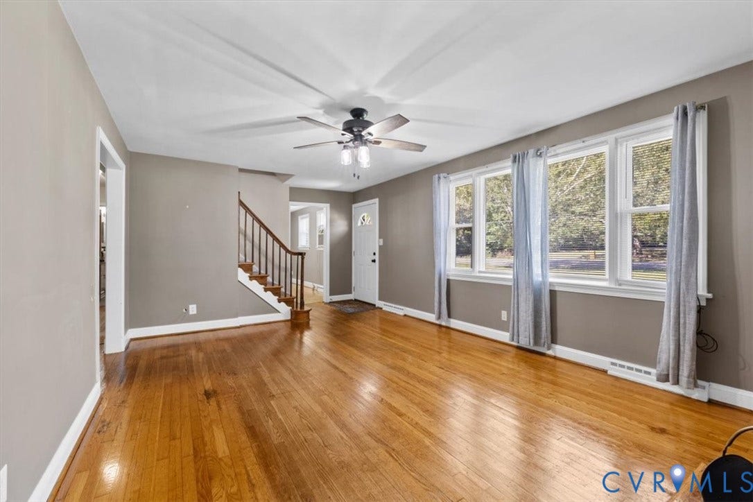 3577 Old Buckingham Road, Powhatan, VA 23139 Wood-finish flooring, multiple windows providing natural light, staircase with wood banister, and a ceiling fan