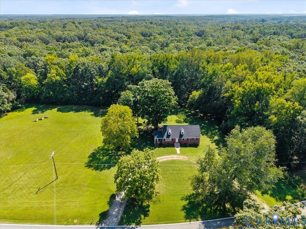 3577 Old Buckingham Road, Powhatan, VA 23139 Brick residence with gabled dormers, surrounded by mature trees and expansive green space