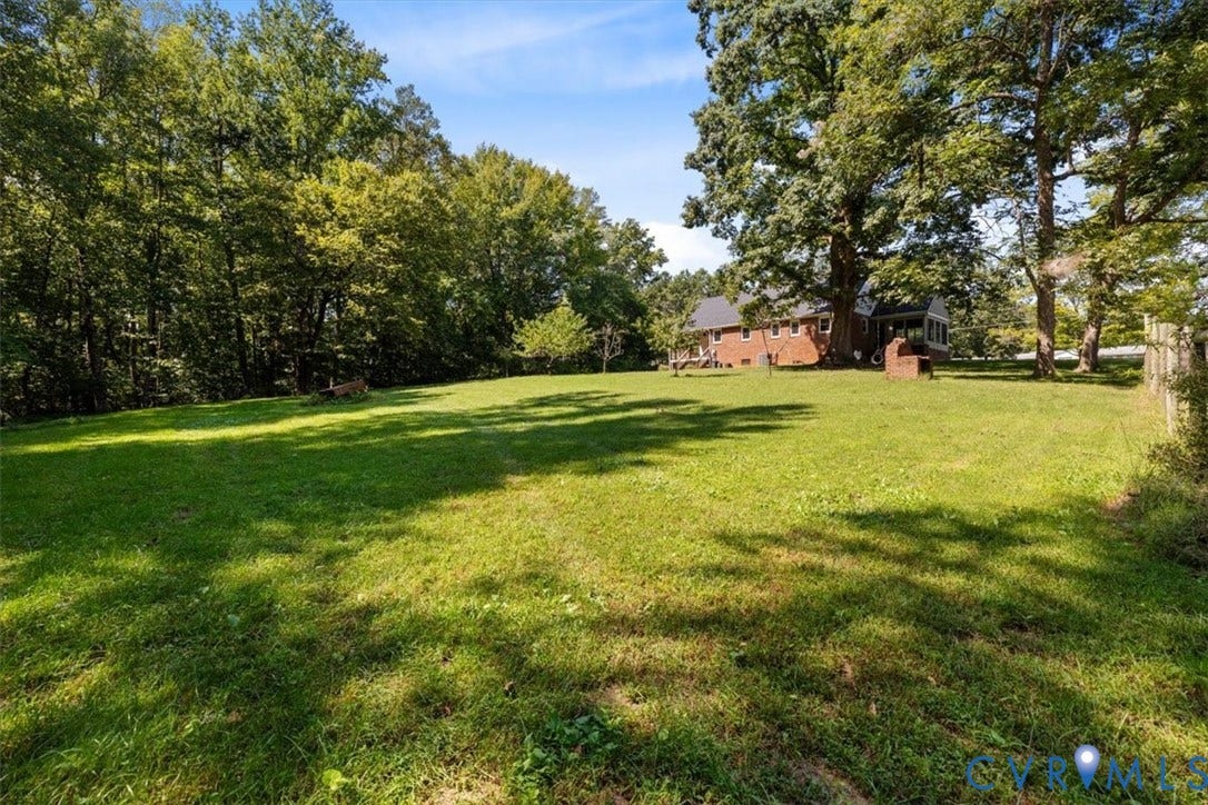 3577 Old Buckingham Road, Powhatan, VA 23139 Expansive grassy yard with mature trees and a partial wood fence