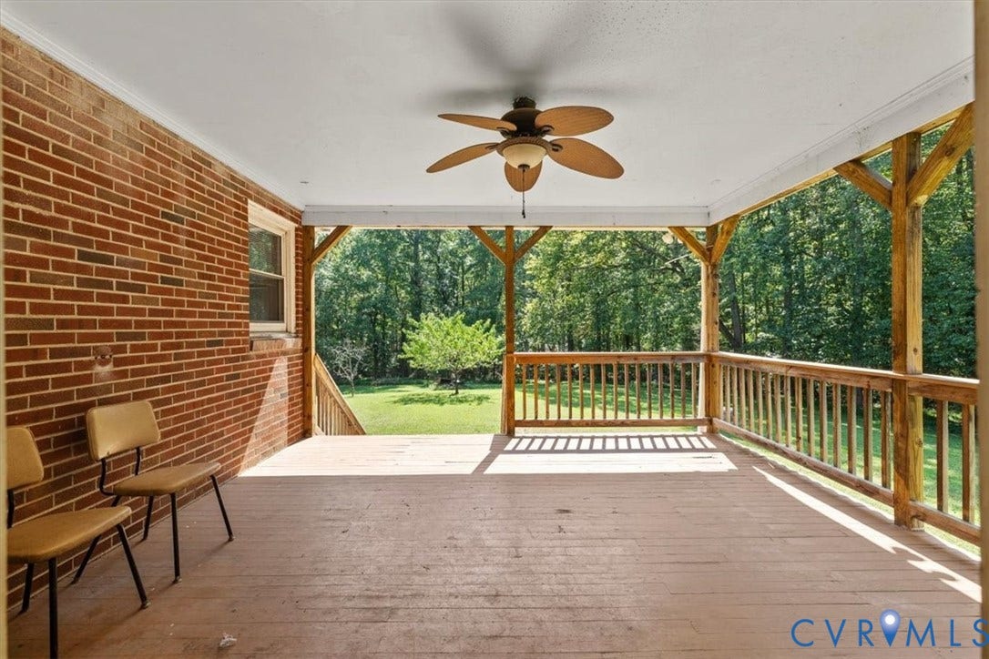 3577 Old Buckingham Road, Powhatan, VA 23139 Covered outdoor deck with a wood-finish floor, wood railings, exposed wood beams, and a ceiling fan